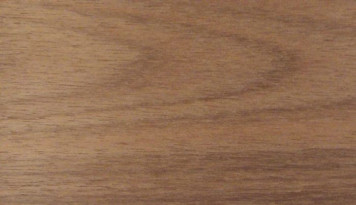 Dark red meranti surface: red-brown with a ribbon figure, close-up.