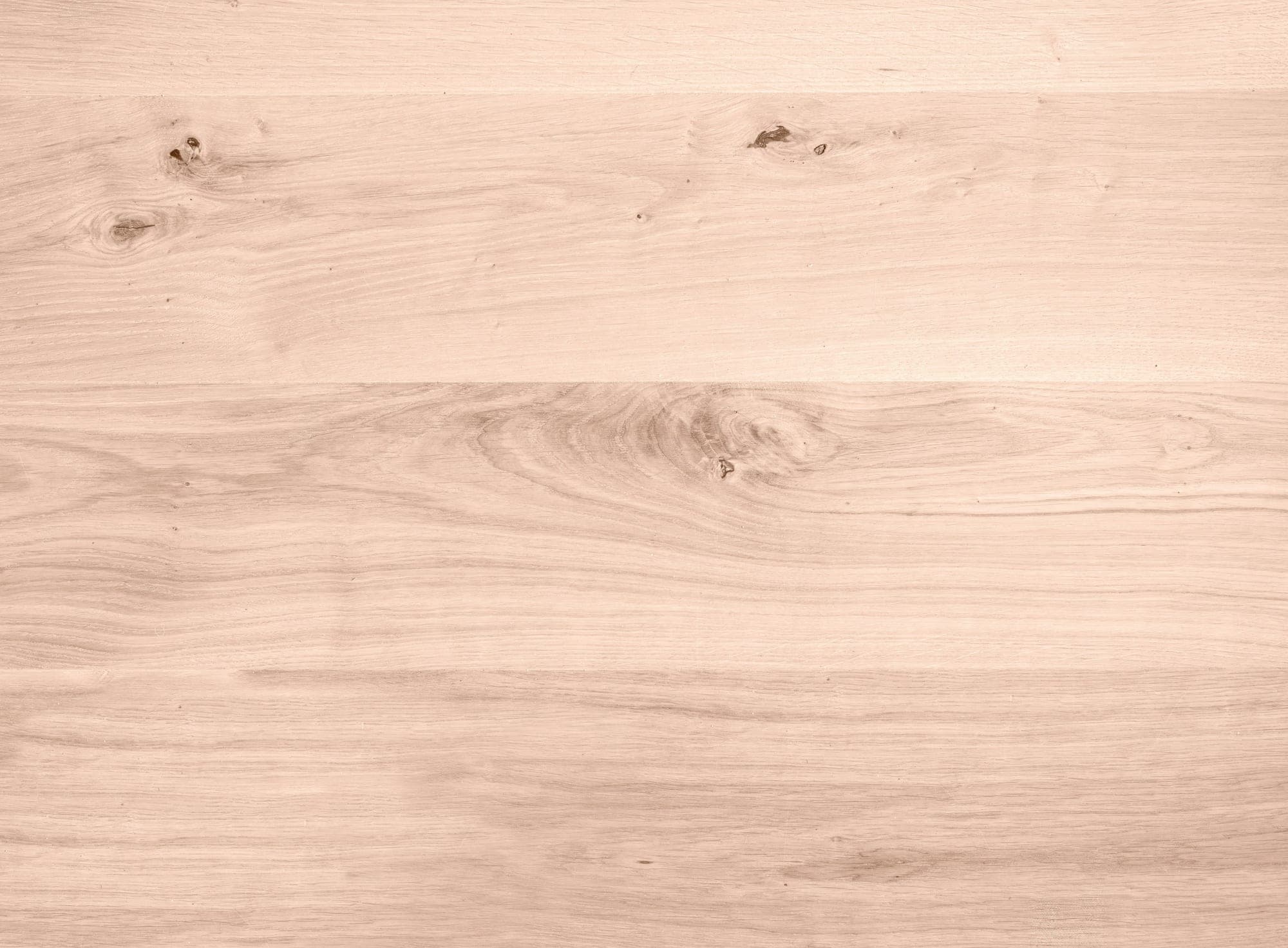 Light oak surface with pronounced grain and small knots, close-up.