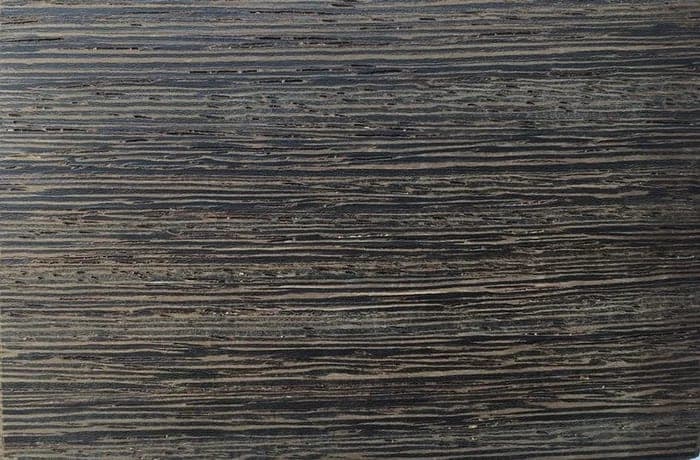 Wenge lumber surface: dark brown to black with light and dark stripes, close-up.